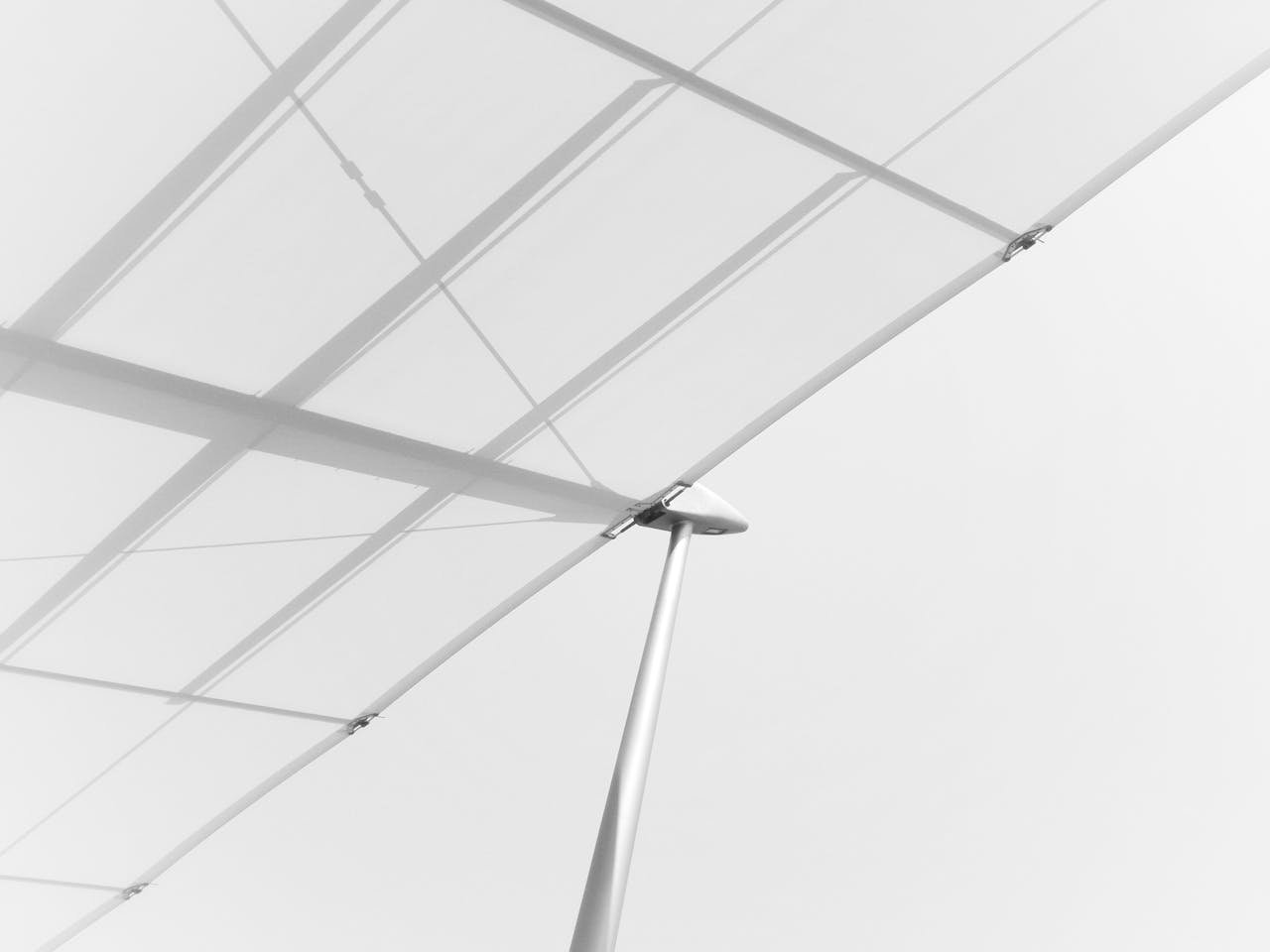 Minimalist white architectural canopy with steel support and design elements.