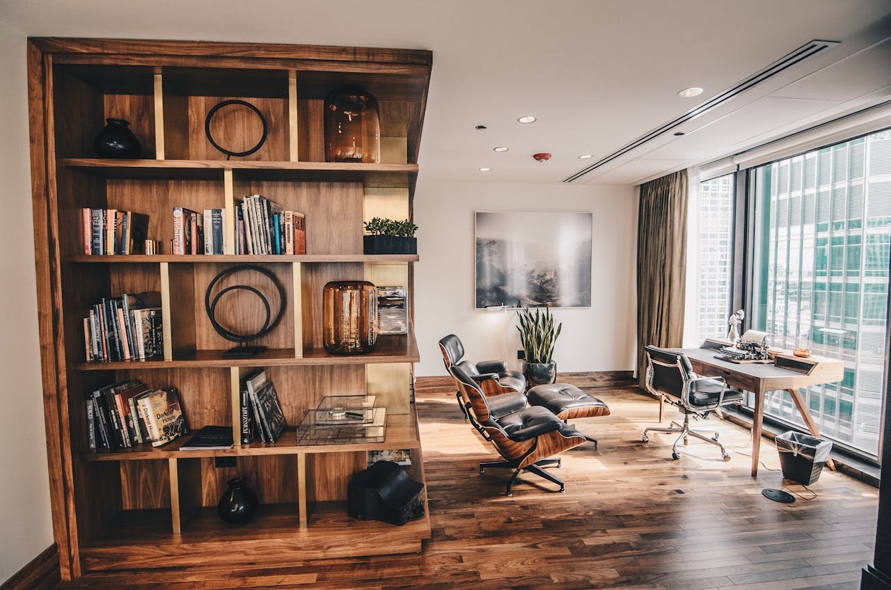 why-choose-us Stylish office space featuring a wooden bookshelf and a minimalist desk setup, ideal for work.